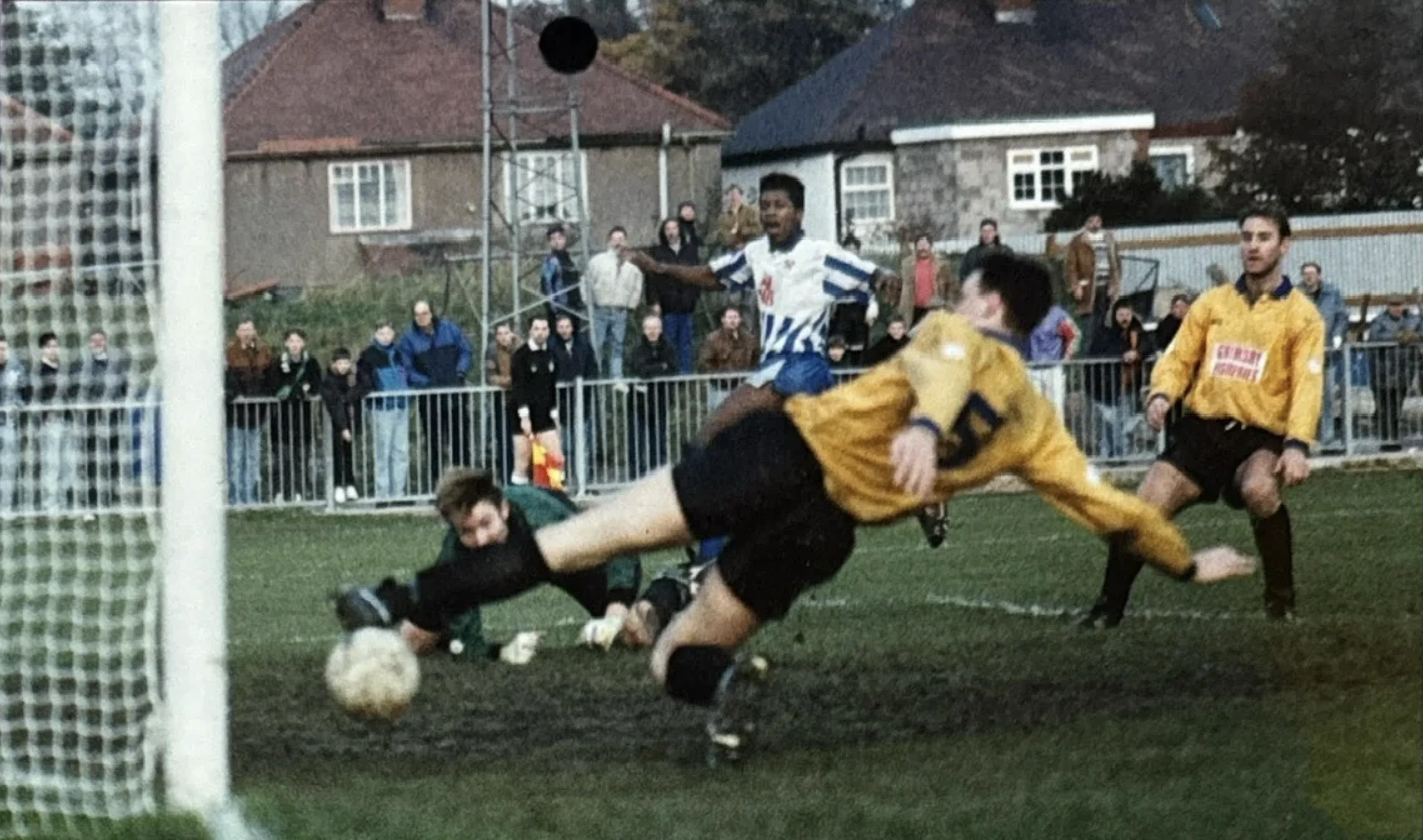 Mark Rosegreen scores, sliding the ball past the diving goalkeeper