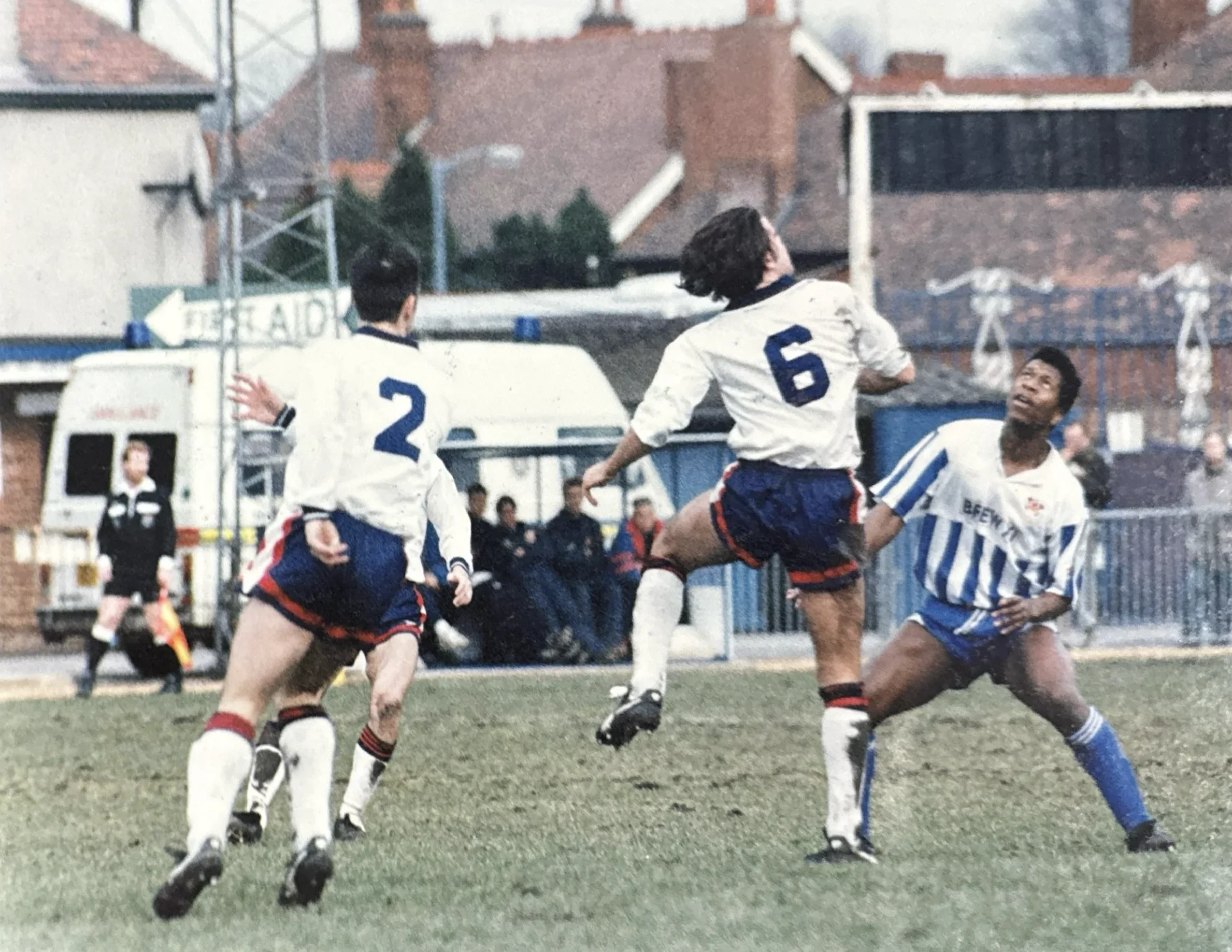 Mark Rosegreen in action in a colour match photograph, opponents numbered 2 and 6